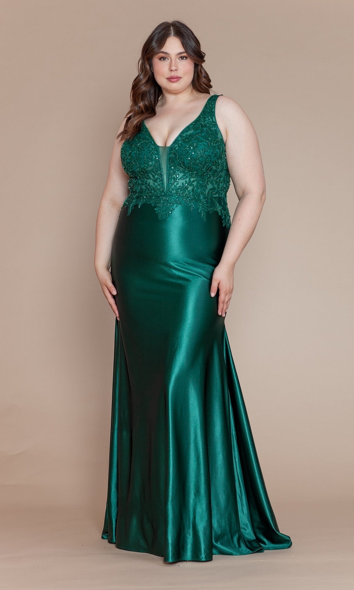 A woman models the Embroidered-Bodice Plus-Size Long Prom Dress W1160, a sleeveless, floor-length emerald green gown with an embroidered bodice and sequin detailing, standing against a plain beige background.